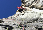 Stoked climber about to make an airy traverse on Traveler Buttress' third pitch.