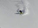 Skier enjoying light powder on Life on the Edge