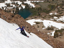 Rider on the flanks of a Sister with Round Top Lake and Caples Lake below.